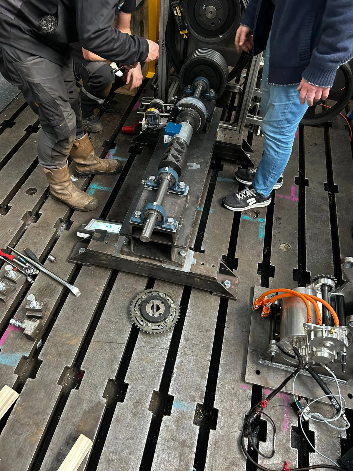 Workshop test rig with a shaft assembly, bearing supports and instrumentation.